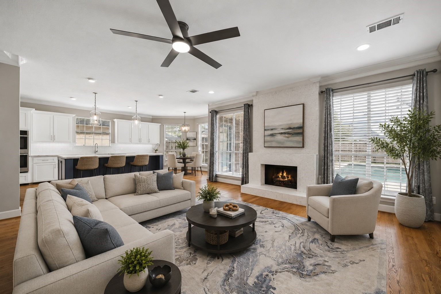 7915 Huddersfield Court Spring, TX 77379 - Photo 2 of 37 A view of the family room showing the open connection to the updated kitchen, with hardwood floors, fireplace, recessed lighting, and ample wall space for furniture placement. - virtually staged