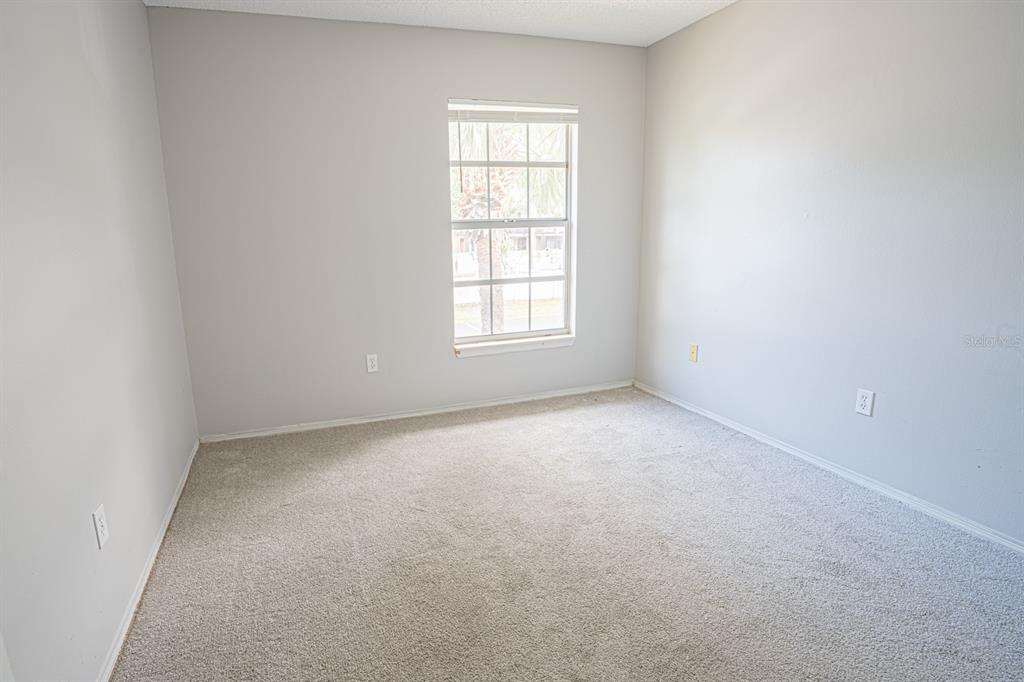 3651 North Goldenrod Road, Unit E205 Winter Park, FL 32792 - Photo 11 of 19 an empty room with a window