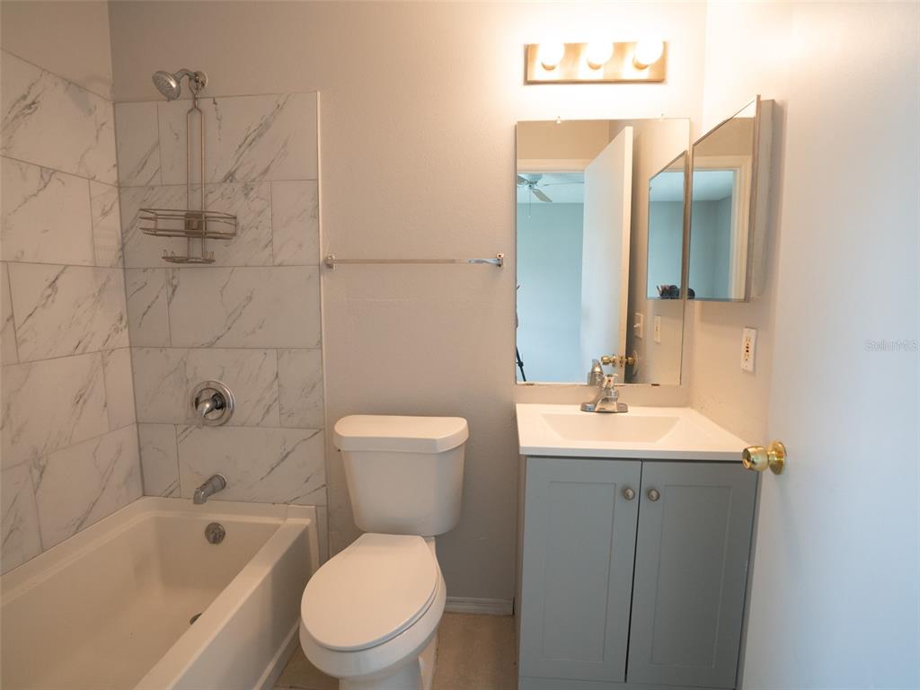 3651 North Goldenrod Road, Unit E205 Winter Park, FL 32792 - Photo 16 of 19 a bathroom with a toilet a sink and bathtub