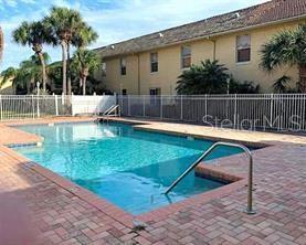 3651 North Goldenrod Road, Unit E205 Winter Park, FL 32792 - Photo 19 of 19 a swimming pool with outdoor seating and yard