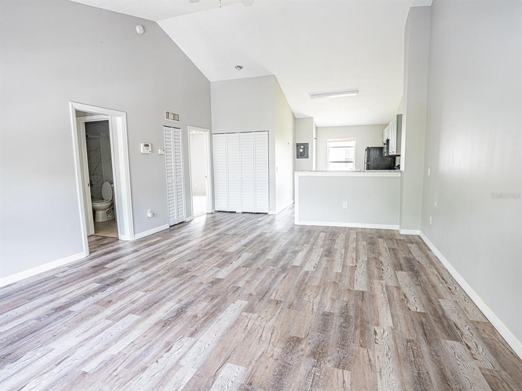 3651 North Goldenrod Road, Unit E205 Winter Park, FL 32792 - Photo 3 of 19 a view of a big room with wooden floor and windows