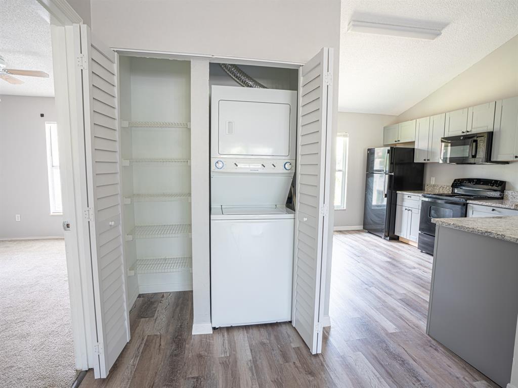 3651 North Goldenrod Road, Unit E205 Winter Park, FL 32792 - Photo 7 of 19 a room view with wooden floor and electronic appliances