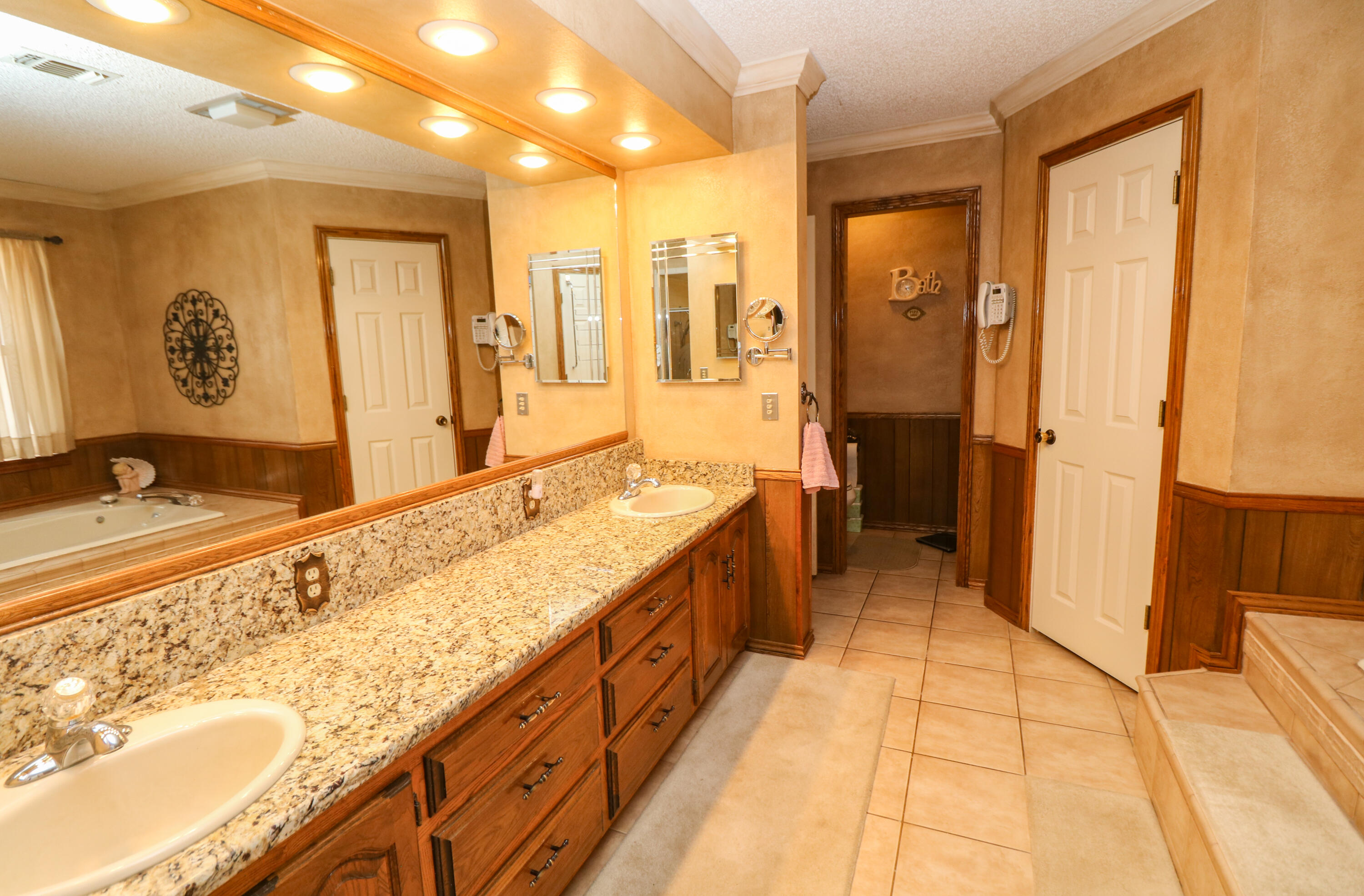 2801 Phelps Avenue Littlefield, TX 79339 - Photo 16 of 38 a spacious bathroom with a granite countertop double vanity sink a mirror and a shower