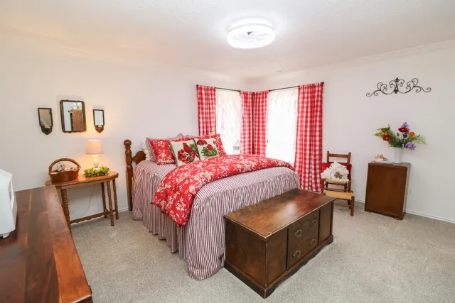 a bed room with a bed and a chair