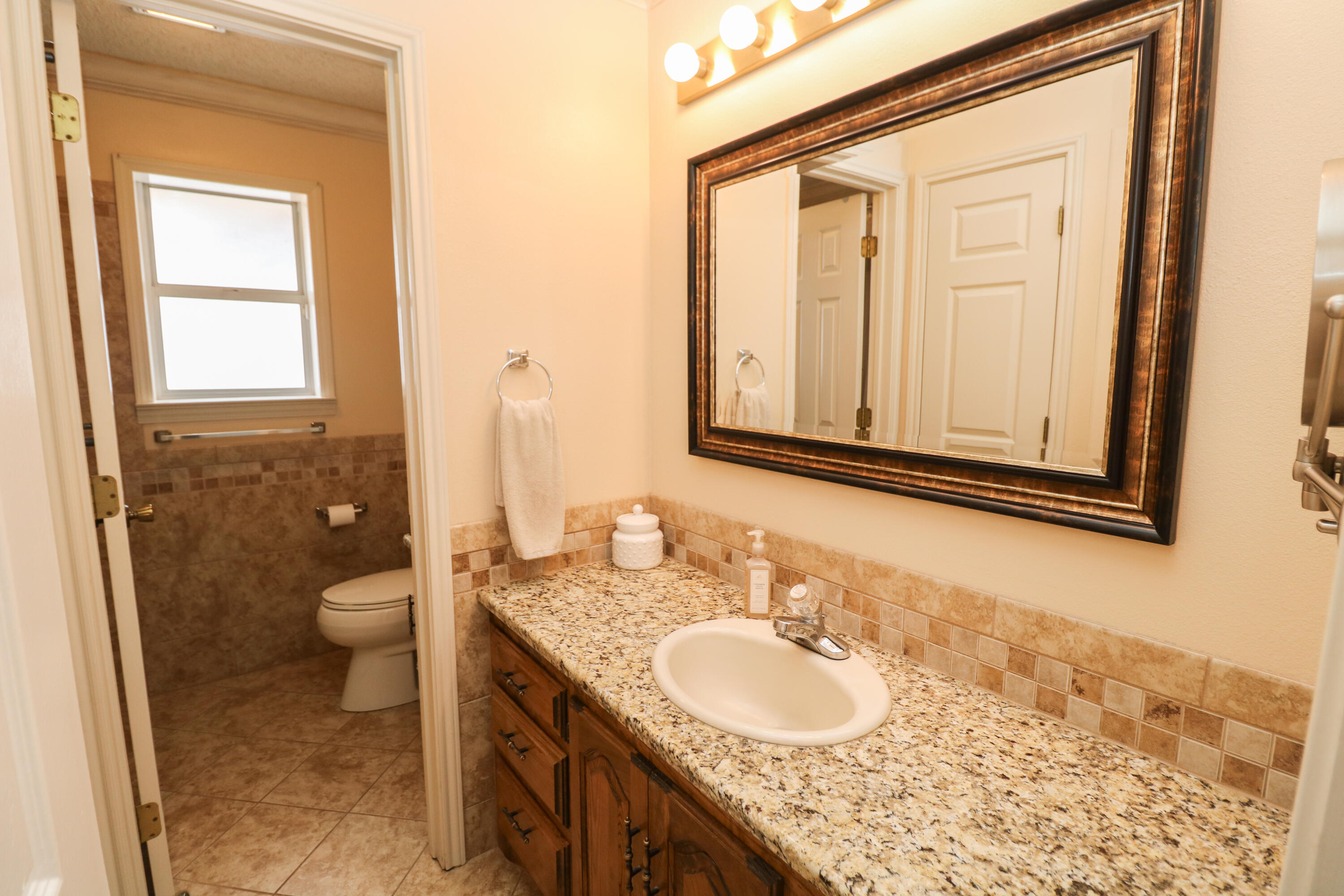 2801 Phelps Avenue Littlefield, TX 79339 - Photo 23 of 38 a bathroom with a granite countertop sink toilet and shower