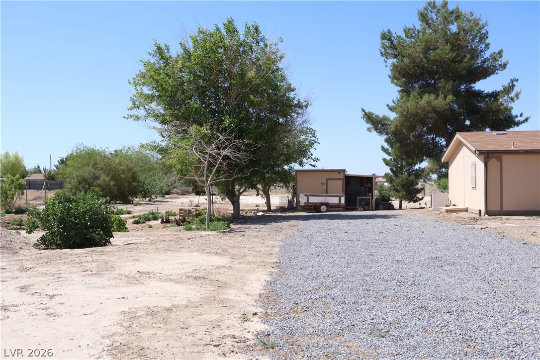 4501 East Kellogg Road Pahrump, NV 89061 - Photo 45 of 52 A spacious lot with ample room for outdoor activities, featuring a gravel parking area.