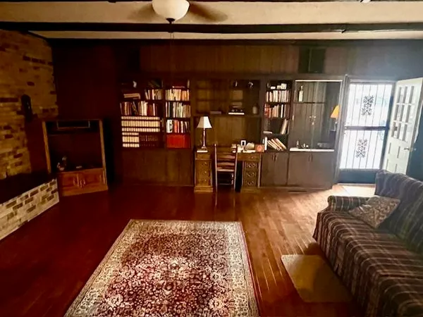 a living room with furniture rug and wooden floor