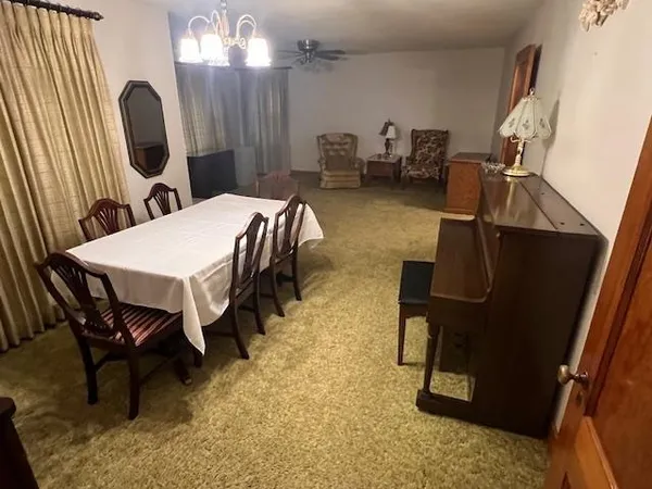 a dining room with furniture and a mirror