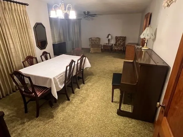 a dining room with furniture and a mirror