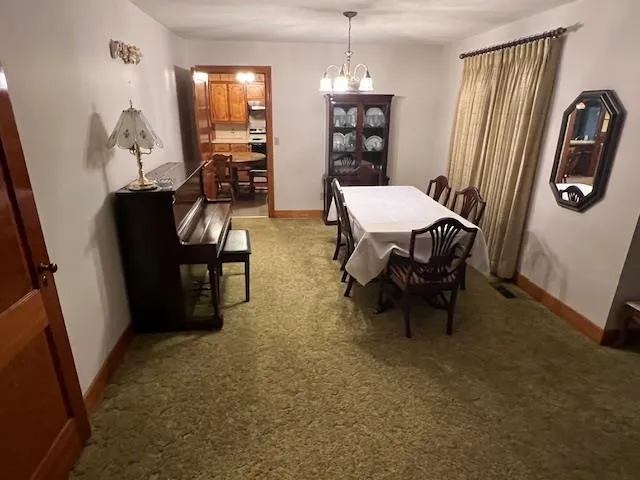 a living room with furniture a table and wooden floor