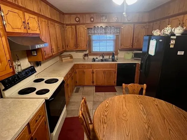 a view of a kitchen with a sink and cabinets