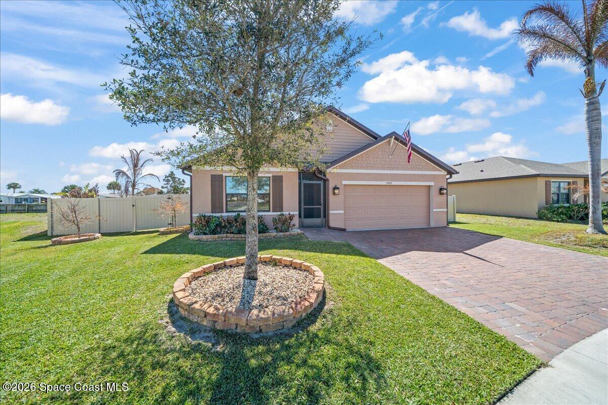 7499 Tourmaline Drive Grant, FL 32949 - Photo 1 of 41 a front view of a house with a yard