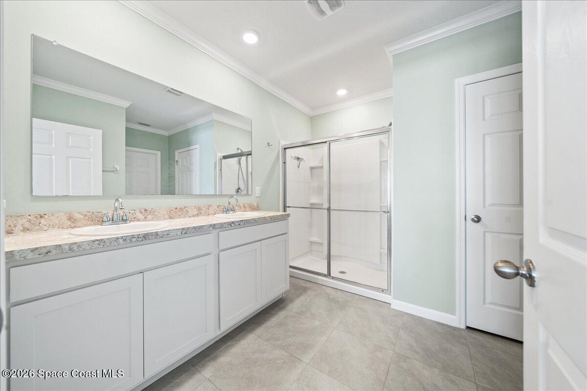 7499 Tourmaline Drive Grant, FL 32949 - Photo 17 of 41 a spacious bathroom with a granite countertop sink mirror and a