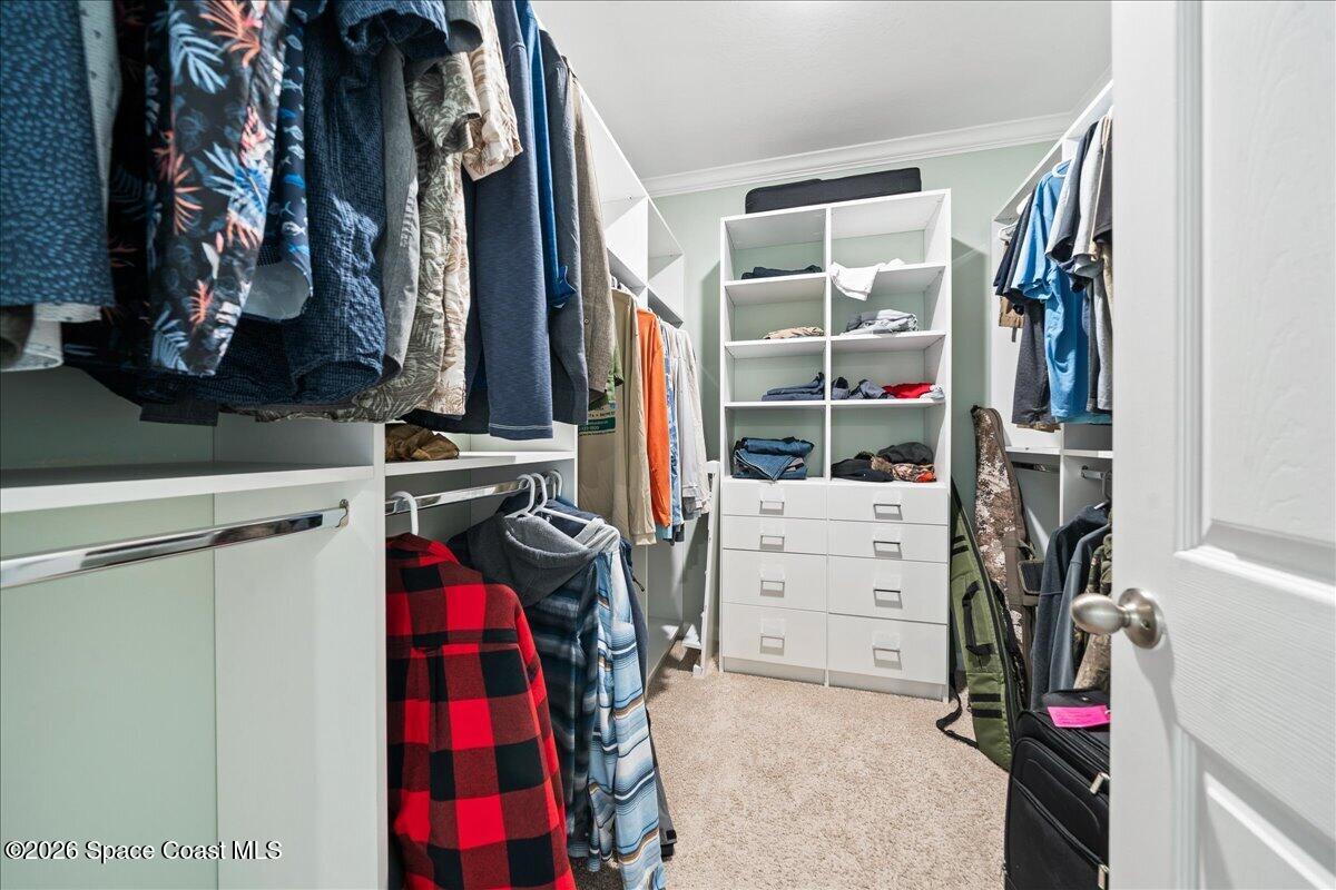 7499 Tourmaline Drive Grant, FL 32949 - Photo 19 of 41 a view of walk in closet with clothes and shoes