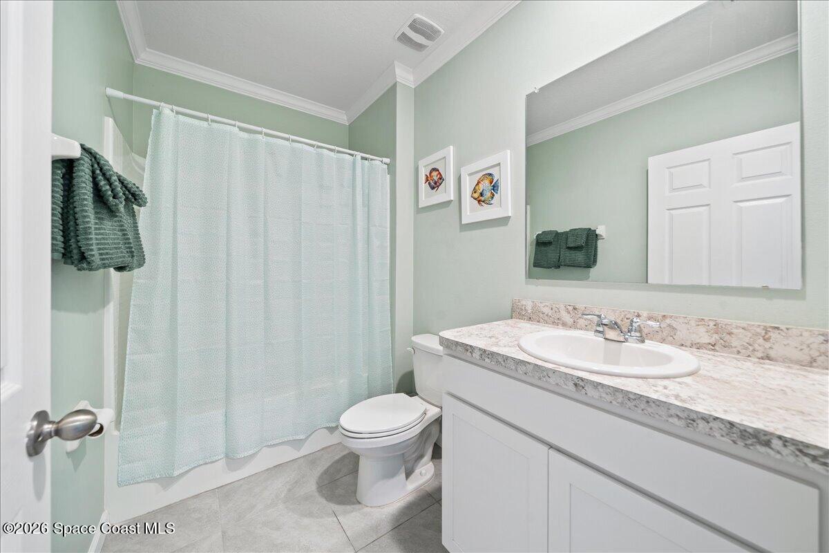 7499 Tourmaline Drive Grant, FL 32949 - Photo 23 of 41 a bathroom with a granite countertop sink toilet and shower