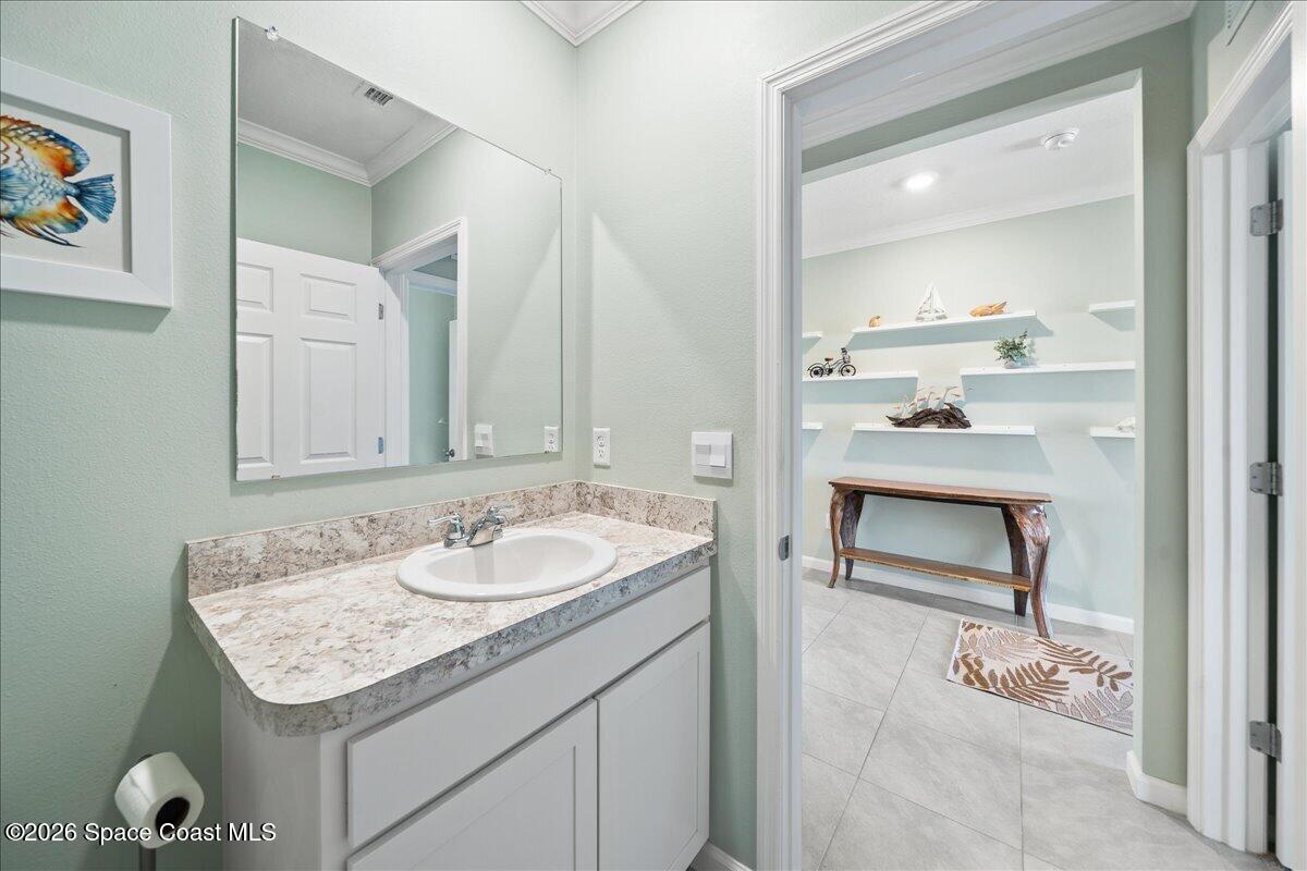 7499 Tourmaline Drive Grant, FL 32949 - Photo 24 of 41 a bathroom with a granite countertop sink and a mirror