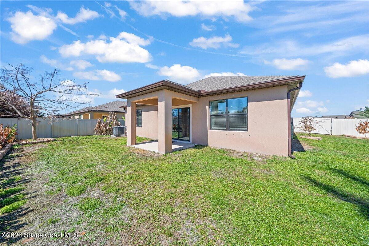 7499 Tourmaline Drive Grant, FL 32949 - Photo 29 of 41 a view of a house with yard and a garden