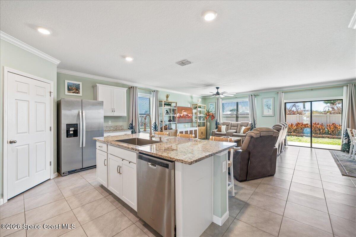 7499 Tourmaline Drive Grant, FL 32949 - Photo 5 of 41 a kitchen with stainless steel appliances granite countertop a sink stove and refrigerator