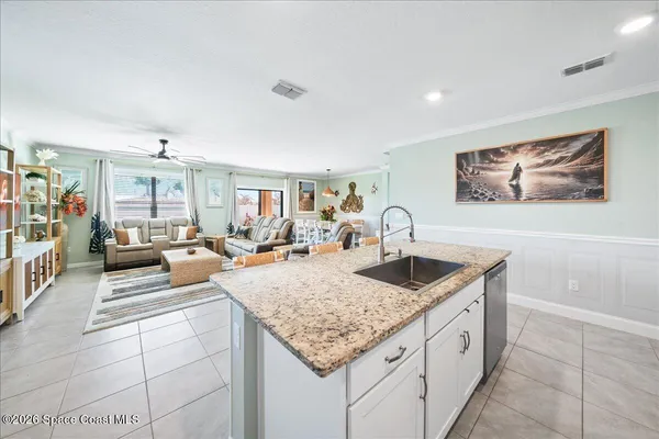 a kitchen with stainless steel appliances granite countertop a stove a sink a microwave a refrigerator and cabinets