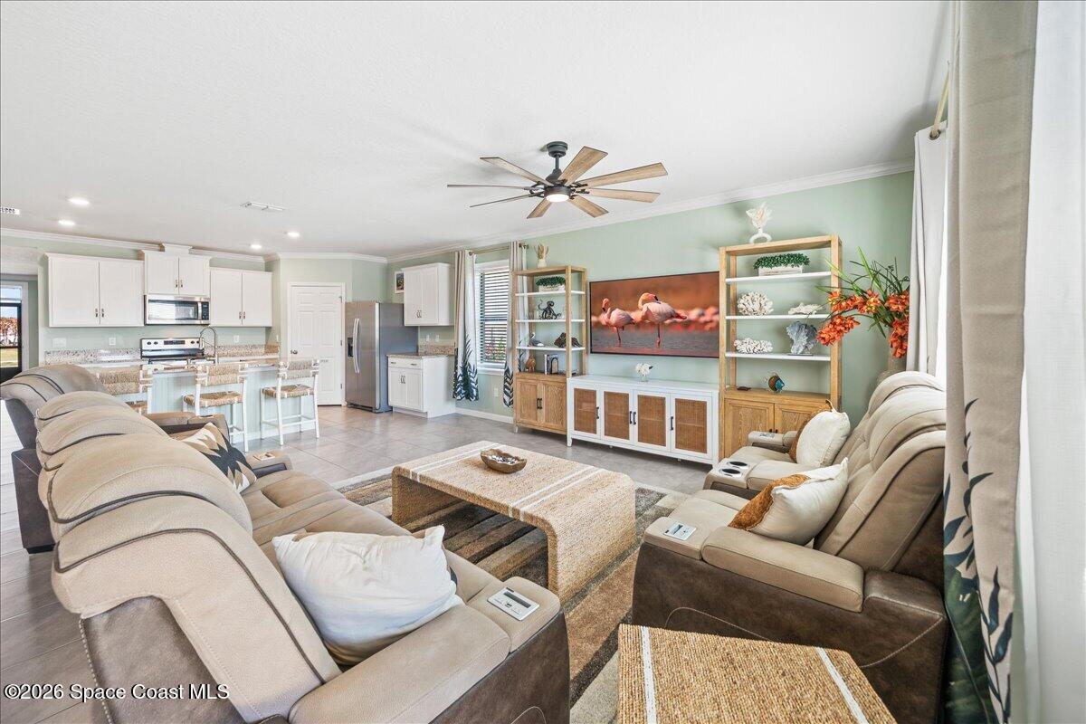 7499 Tourmaline Drive Grant, FL 32949 - Photo 8 of 41 a living room with furniture a ceiling fan and a window