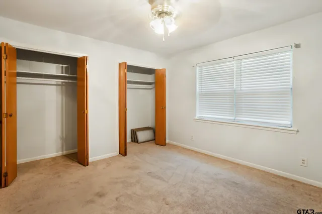 an empty room with windows and closet