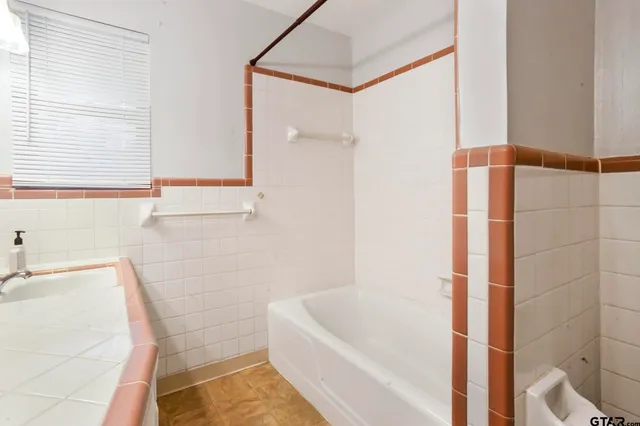 a bathroom with a bathtub and a shower