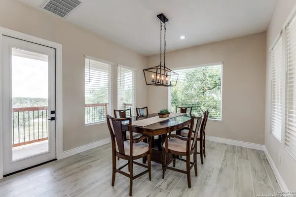 a view of a dining room with furniture window and wooden floor