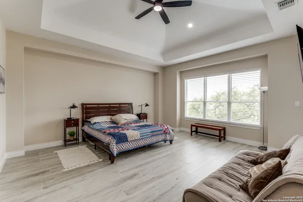 a bedroom with a bed window and a table
