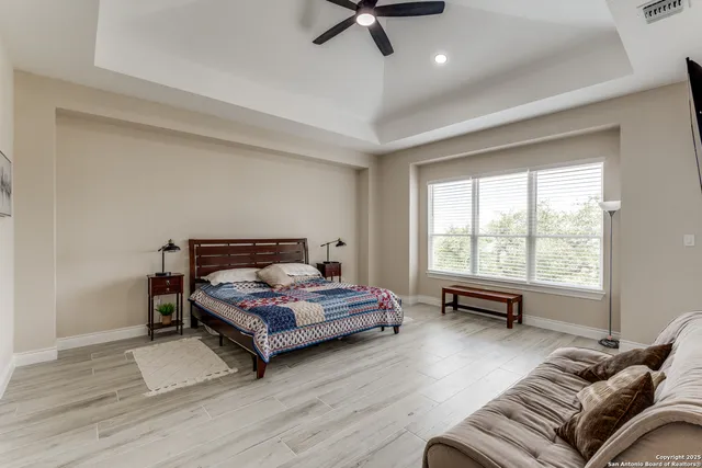 a bedroom with a bed window and a table