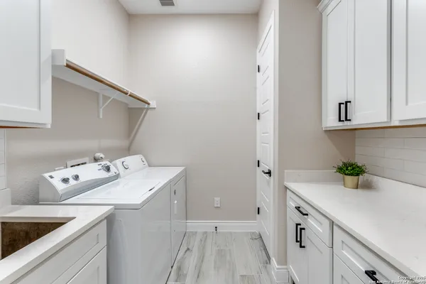 a utility room with sink washer and dryer
