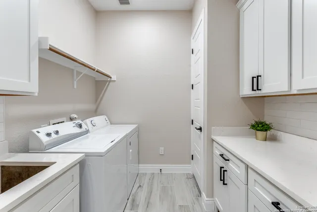 a utility room with sink washer and dryer