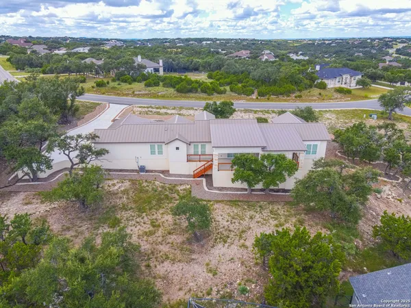 an aerial view of residential houses with outdoor space and ocean view