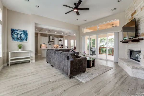 a living room with furniture a flat screen tv and a fireplace