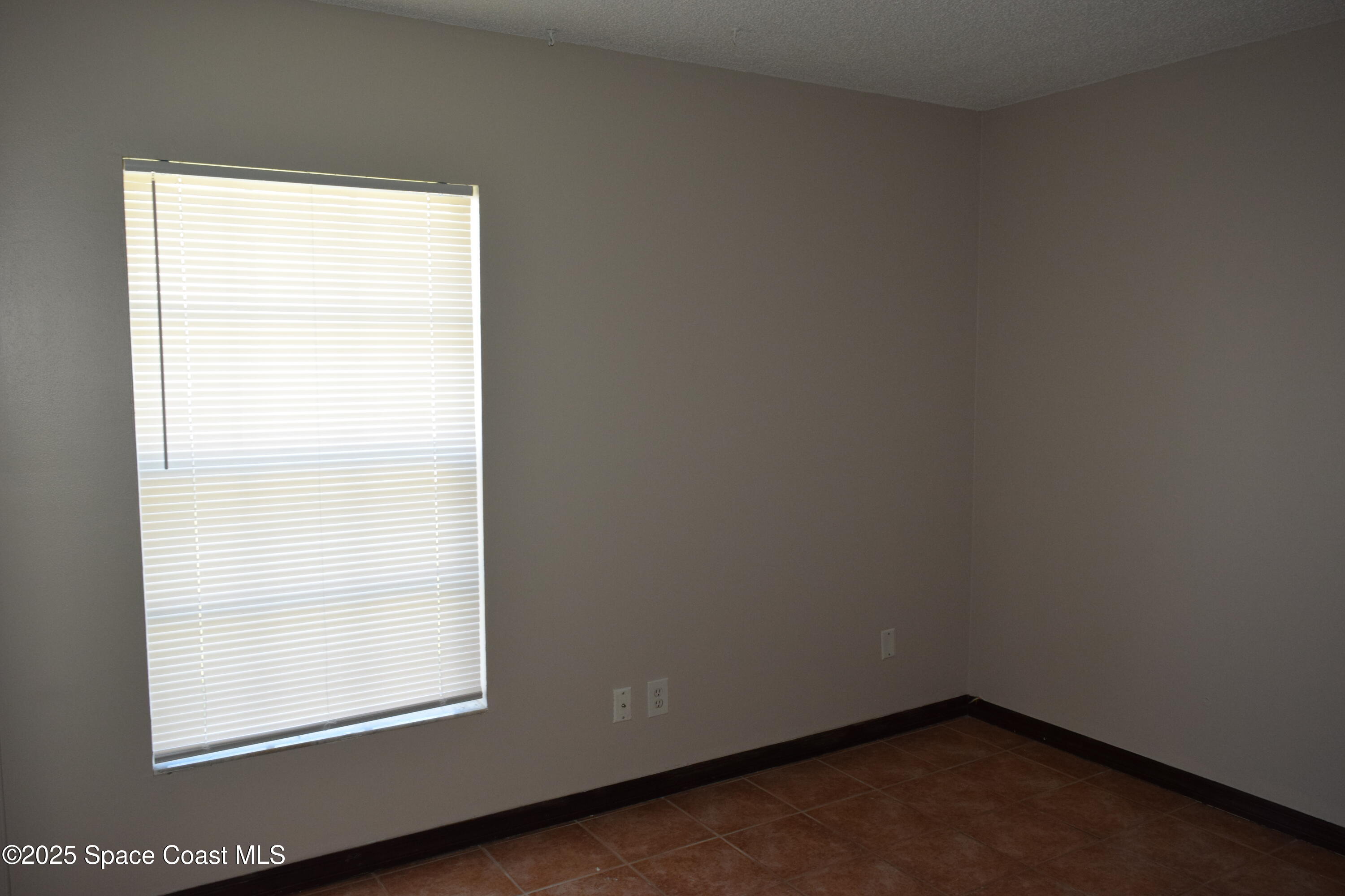 1941 Talloak Road Melbourne, FL 32935 - Photo 16 of 34 an empty room with a window