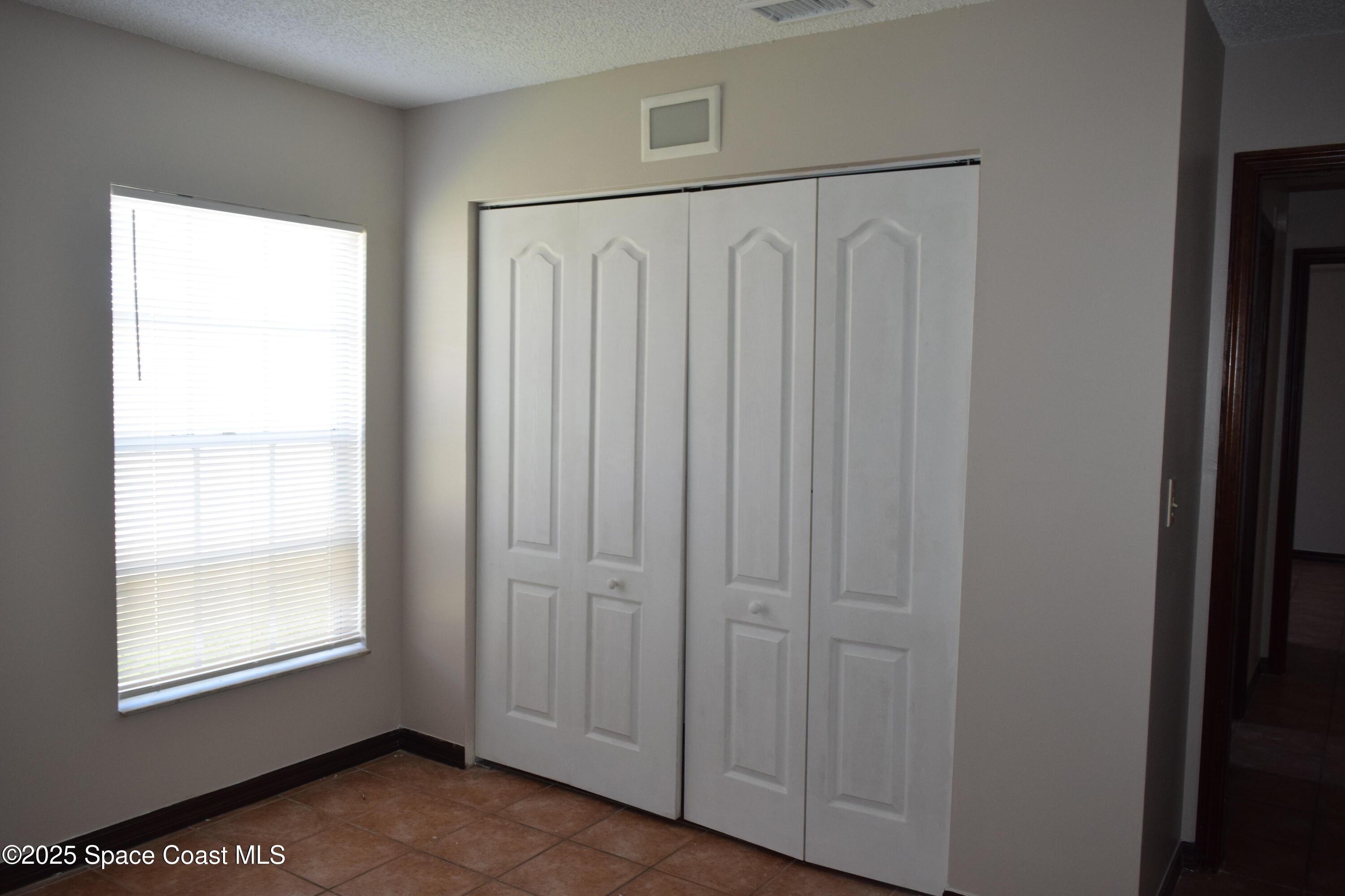 1941 Talloak Road Melbourne, FL 32935 - Photo 18 of 34 a view of a small space with wooden floor and a window