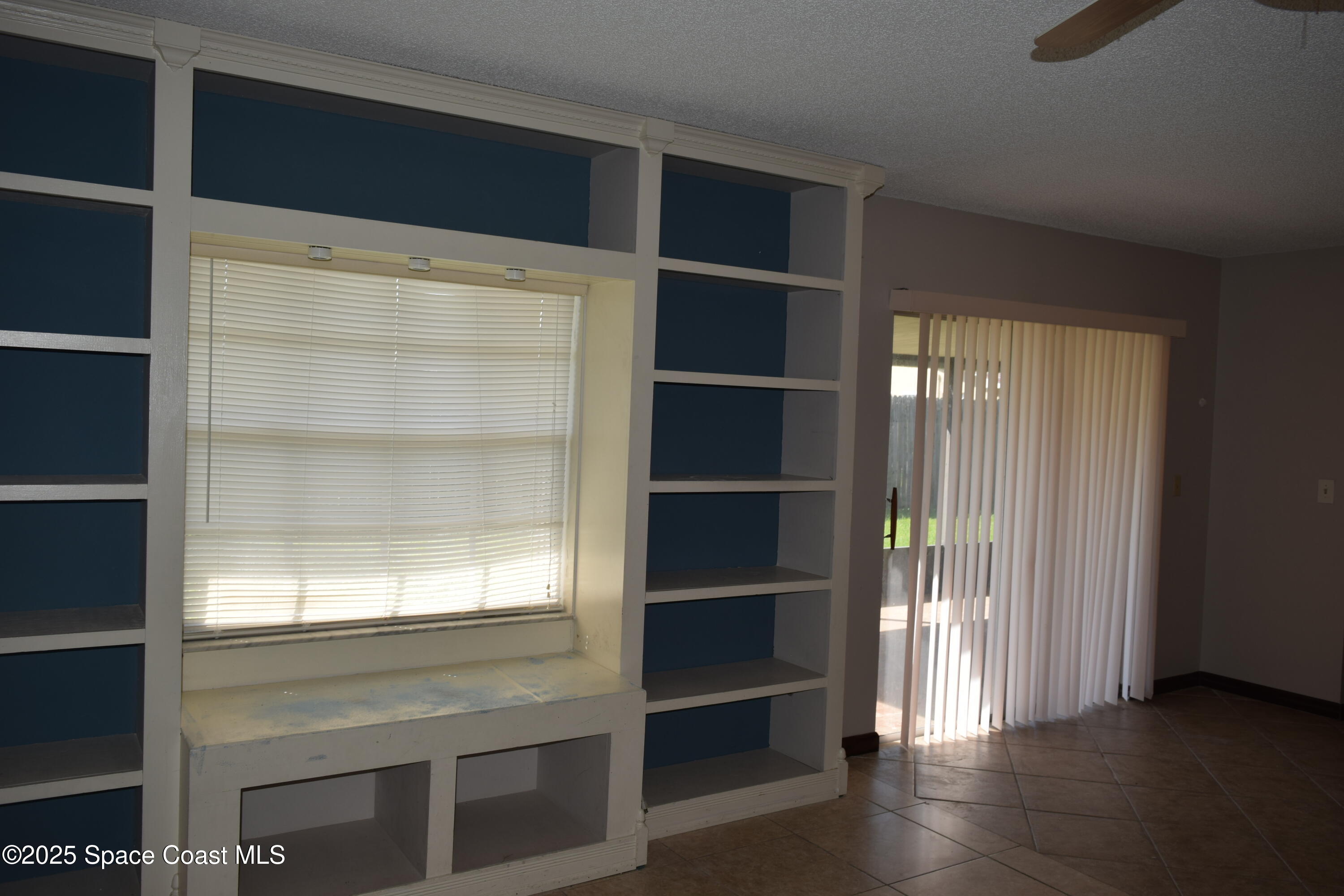 1941 Talloak Road Melbourne, FL 32935 - Photo 28 of 34 a view of an empty room with wooden floor and a window