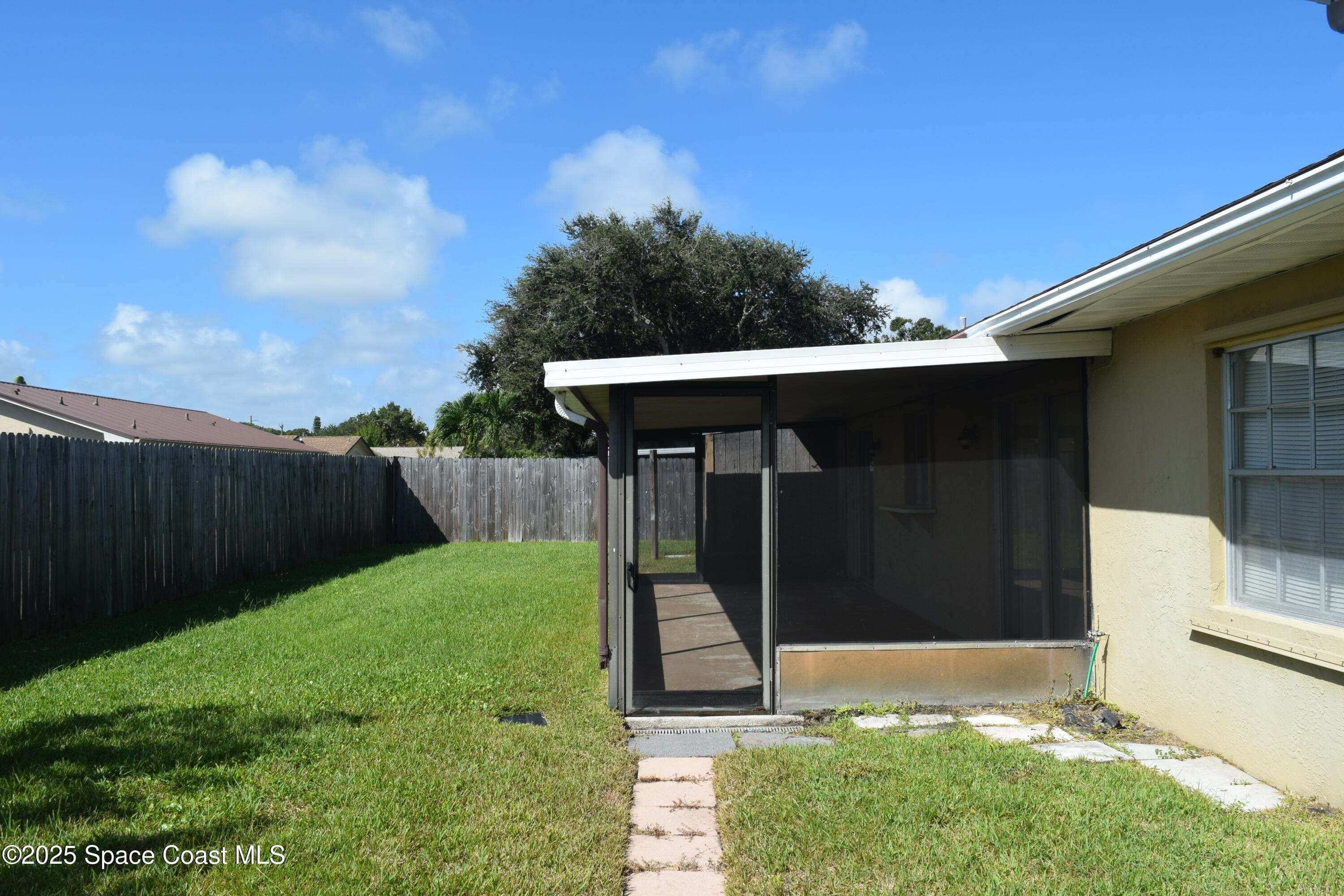 1941 Talloak Road Melbourne, FL 32935 - Photo 33 of 34 a backyard of a house with lots of green space