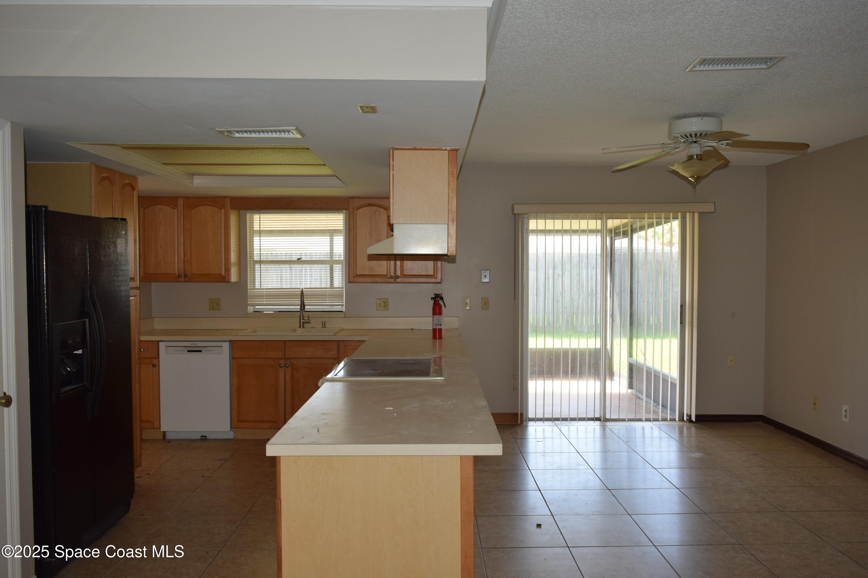 1941 Talloak Road Melbourne, FL 32935 - Photo 8 of 34 a kitchen with a sink a counter top space and stainless steel appliances