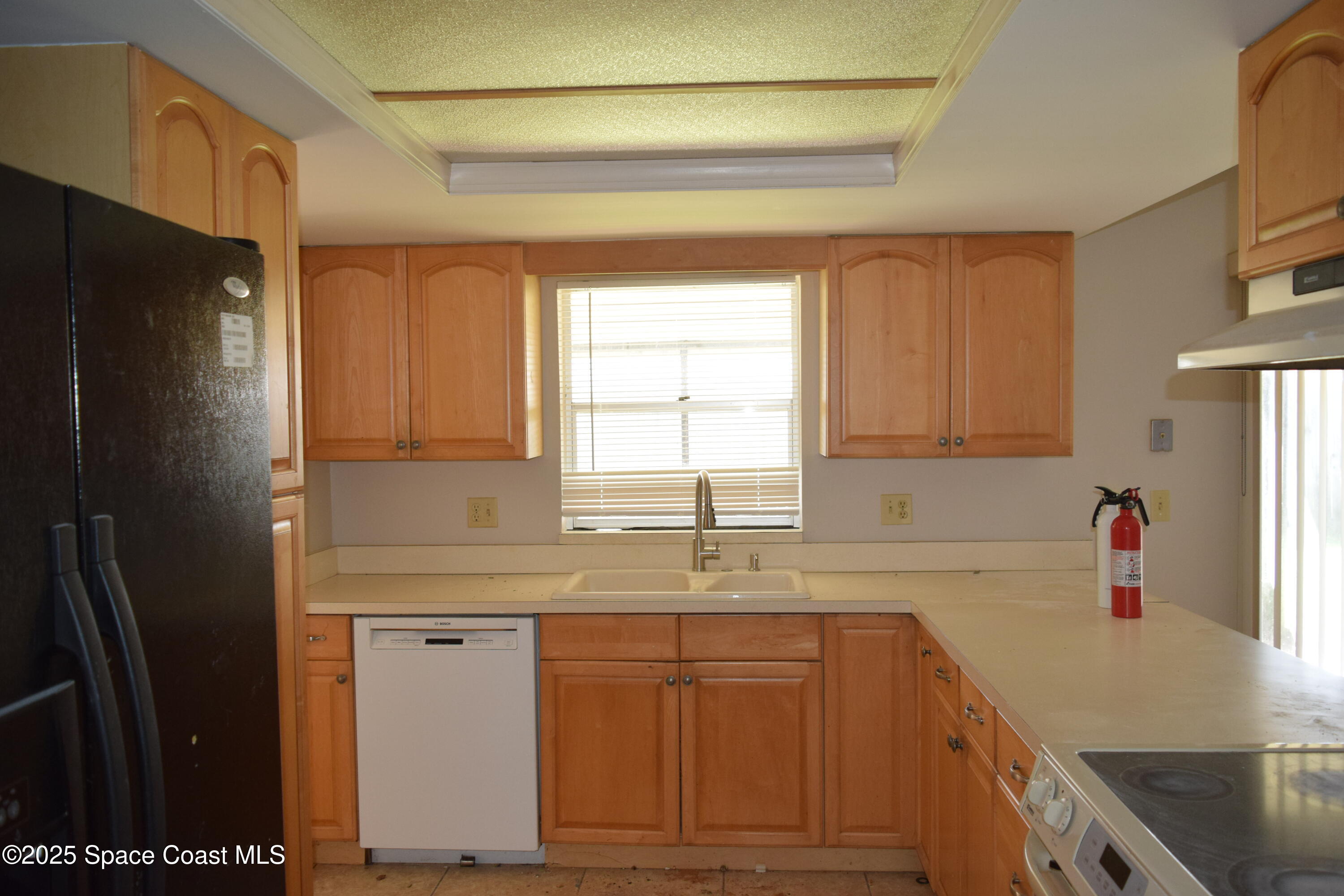 1941 Talloak Road Melbourne, FL 32935 - Photo 9 of 34 a kitchen with a sink a refrigerator and window