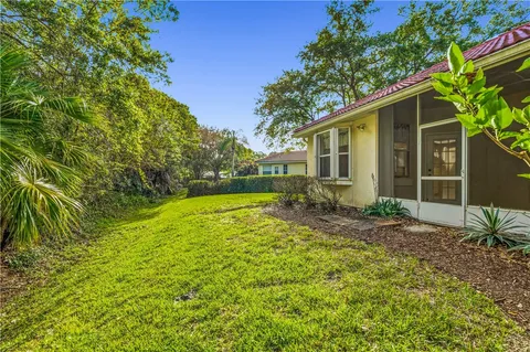 a yellow house with trees in front of it