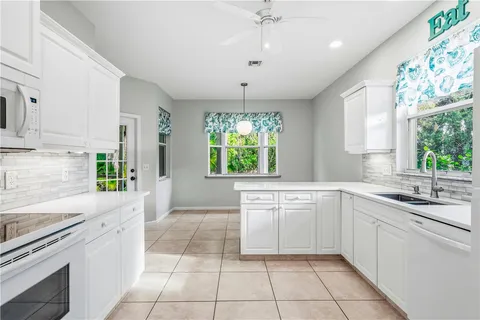 a kitchen with a white cabinets and white appliances