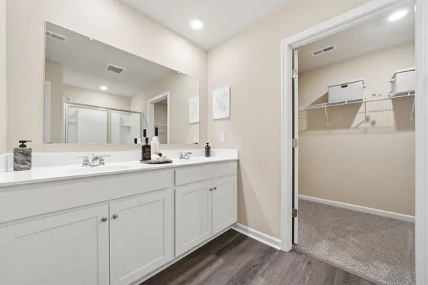 a bathroom with a double vanity sink and mirror