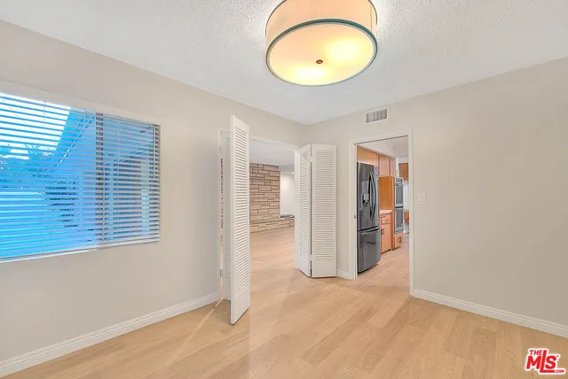 a kitchen with stainless steel appliances granite countertop a sink and a refrigerator