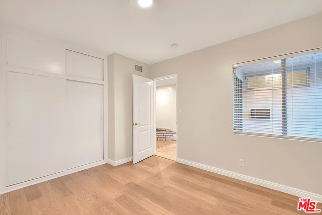 a bathroom with a tub a sink and a large mirror