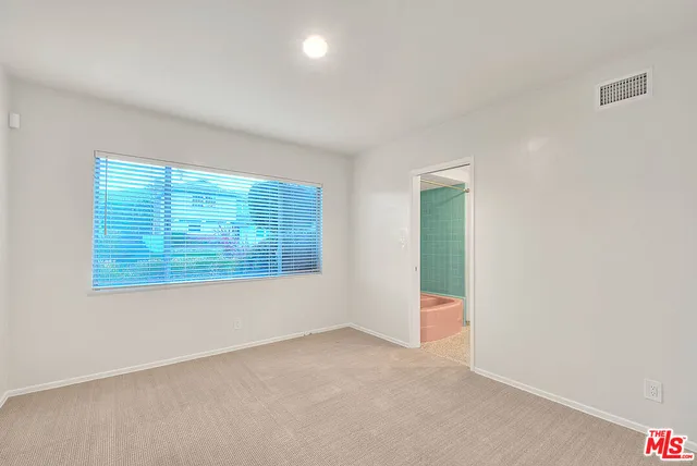 a bathroom with a toilet a sink and a mirror