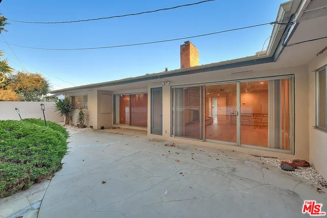 a kitchen with a refrigerator and a stove