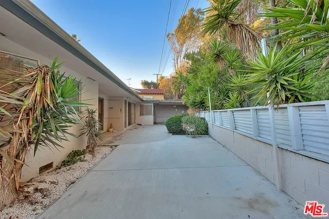 a view of a livingroom with wooden floor and a chandelier