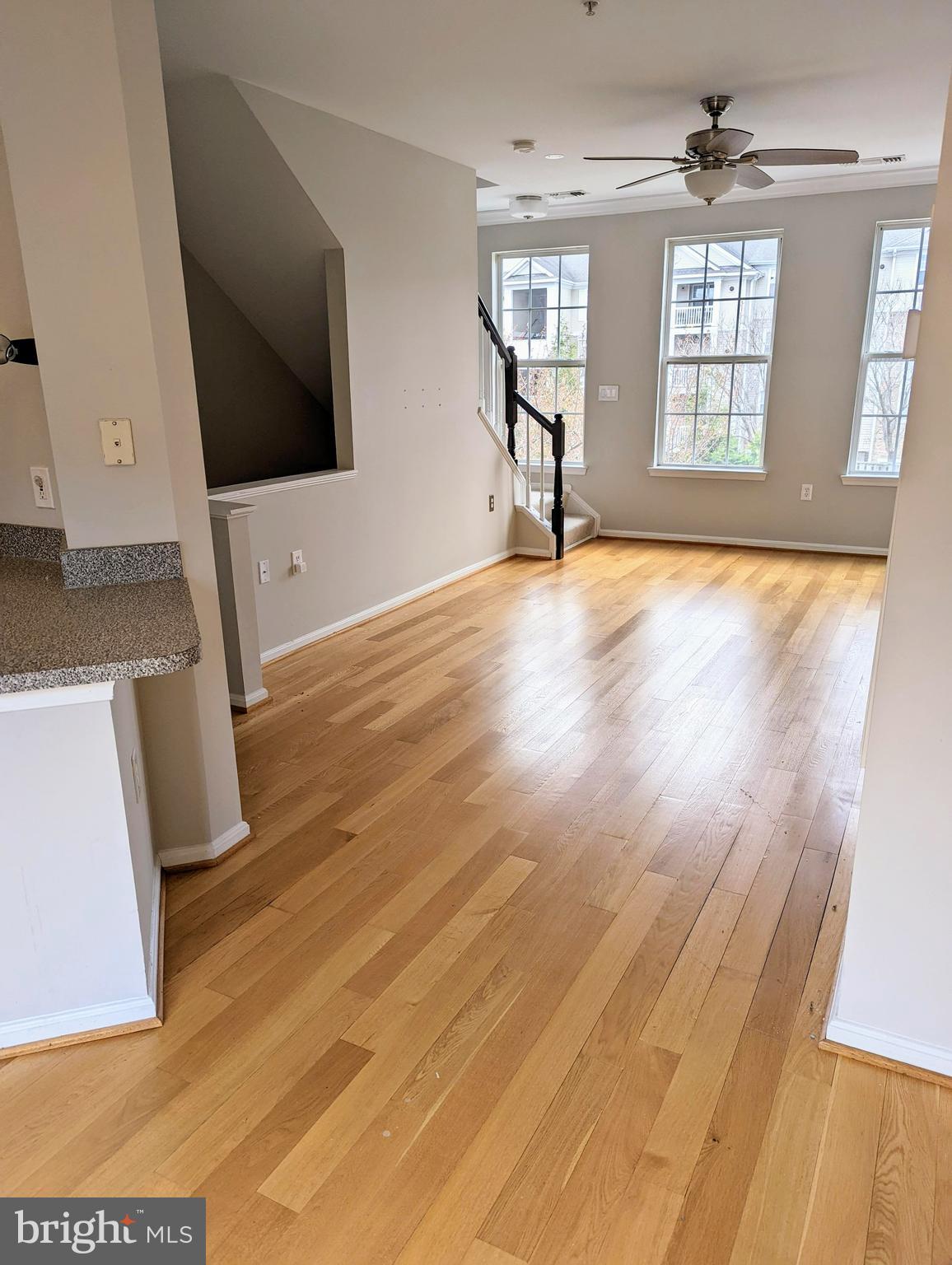21765 Ascot Court Ashburn, VA 20147 - Photo 13 of 32 an empty room with wooden floor and windows