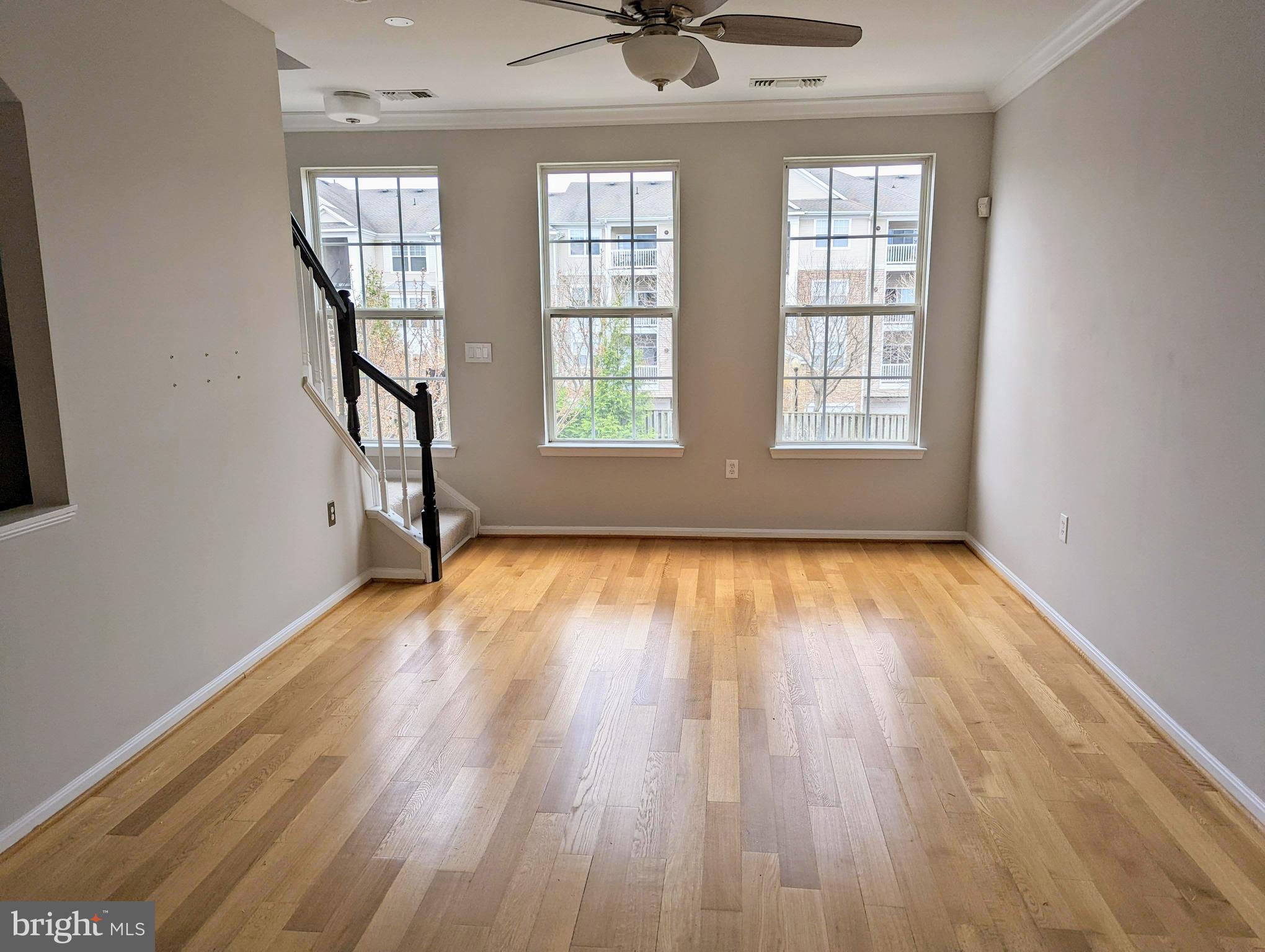 21765 Ascot Court Ashburn, VA 20147 - Photo 14 of 32 an empty room with wooden floor and windows