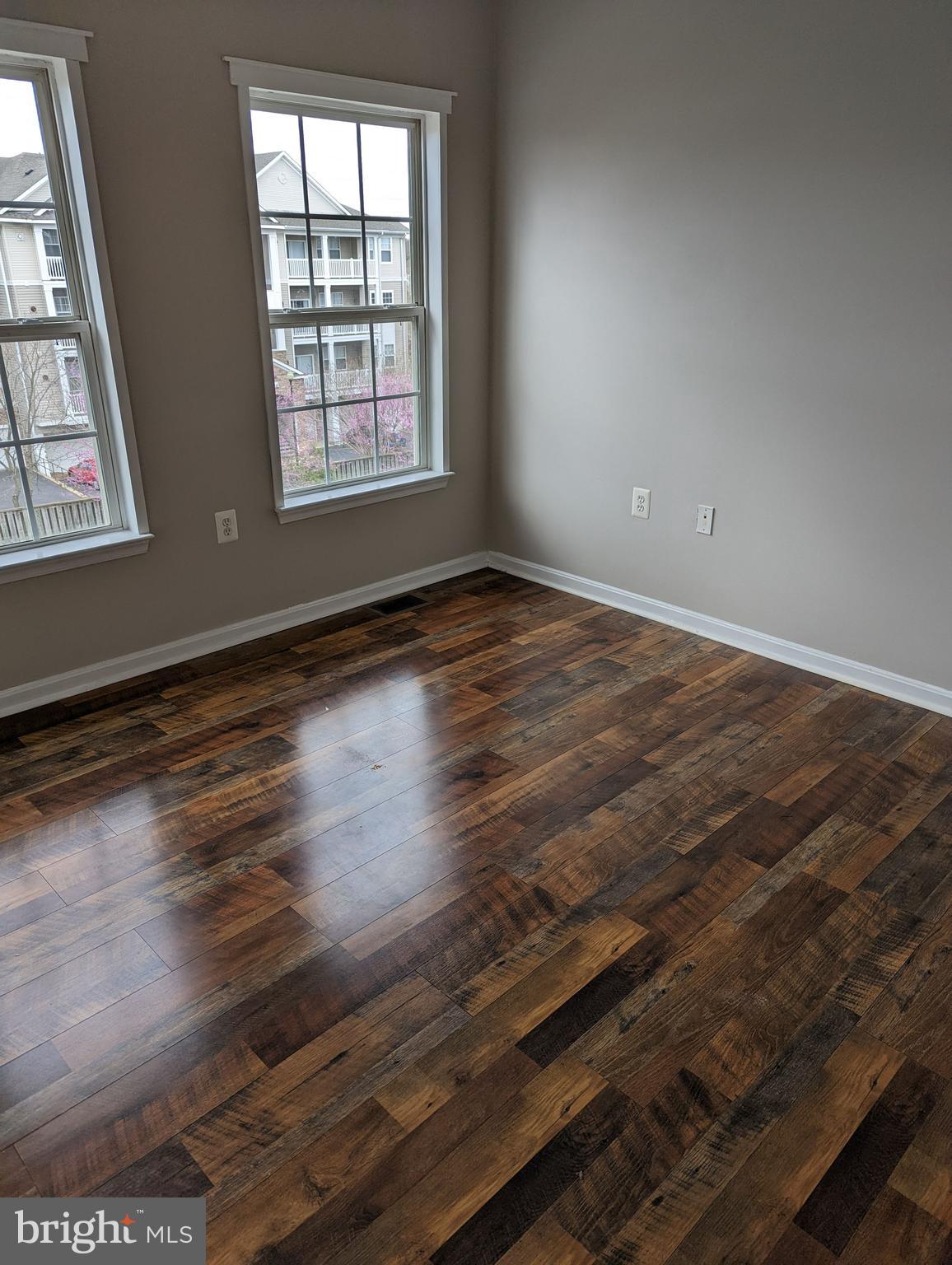 21765 Ascot Court Ashburn, VA 20147 - Photo 22 of 32 an empty room with wooden floor and windows